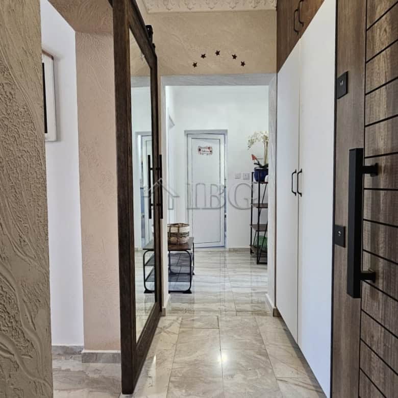 Bright and modern apartment corridor with elegant decor and natural light.