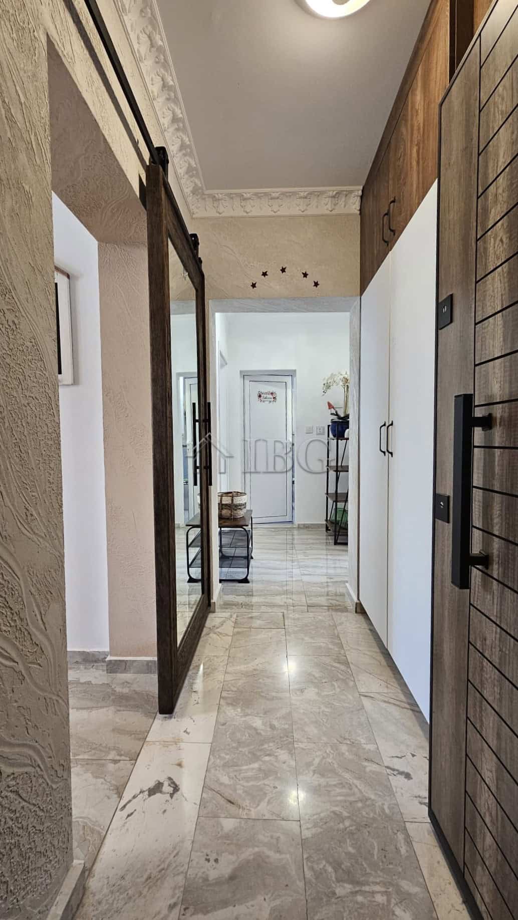Bright and modern apartment corridor with elegant decor and natural light.