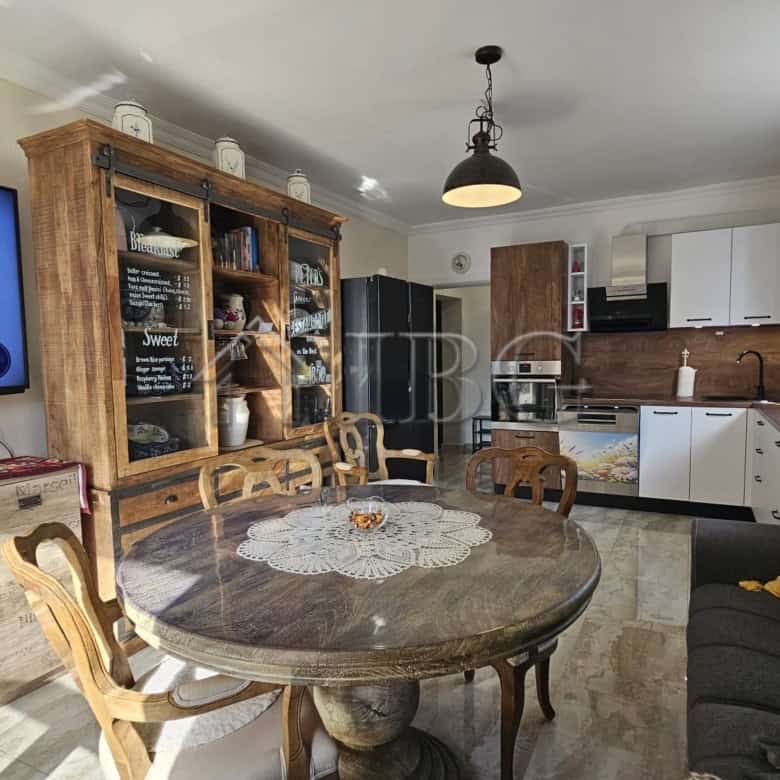 Modern sunny beach apartment with open-plan living and kitchen area.