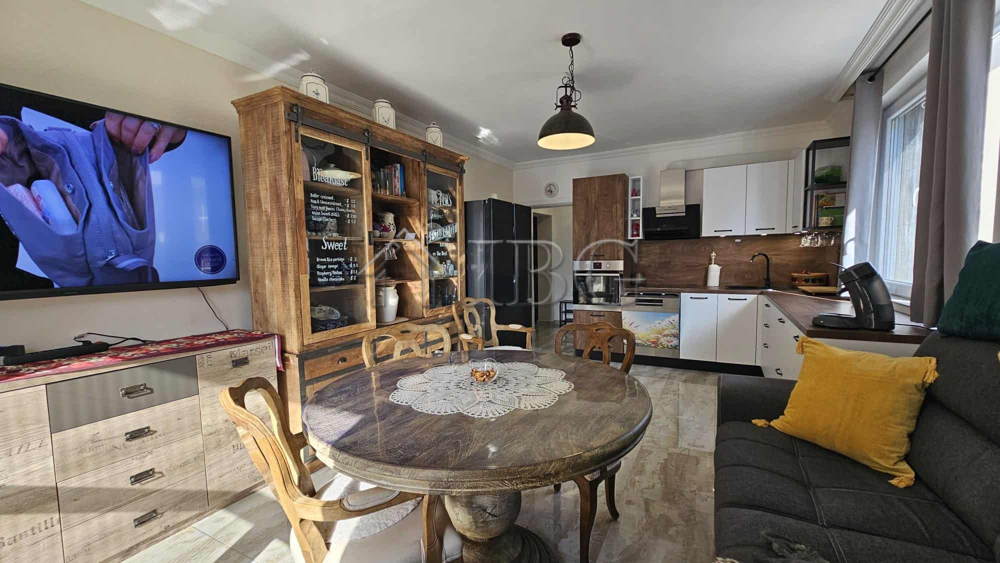 Modern sunny beach apartment with open-plan living and kitchen area.