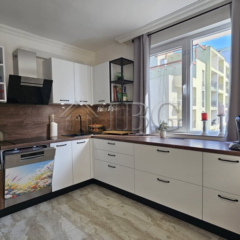 Bright and modern kitchen in a spacious Sunny Beach apartment with large windows and contemporary ap.