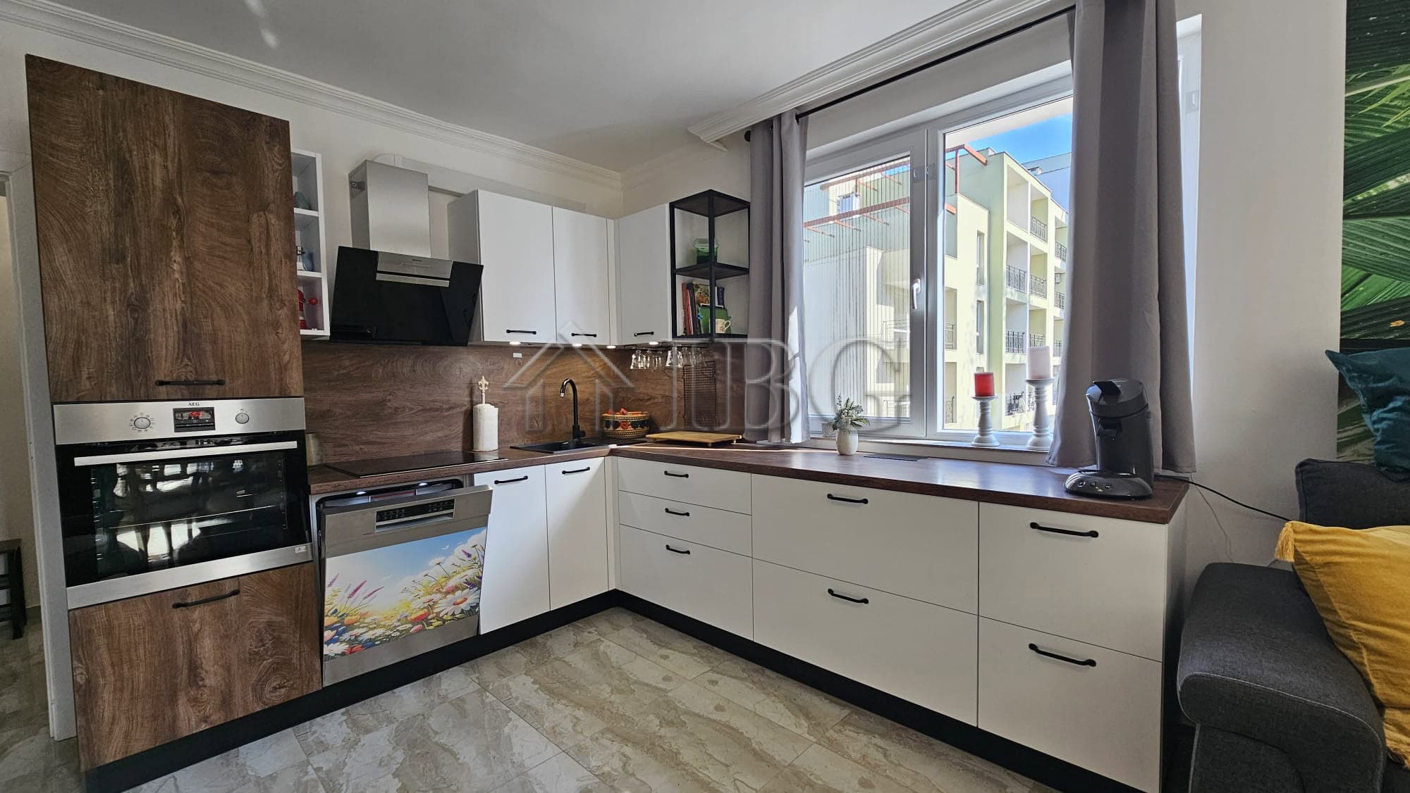 Bright and modern kitchen in a spacious Sunny Beach apartment with large windows and contemporary ap.