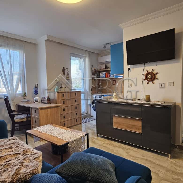 Bright living room with large windows and modern furnishings in Magnolia 6, Sunny Beach.