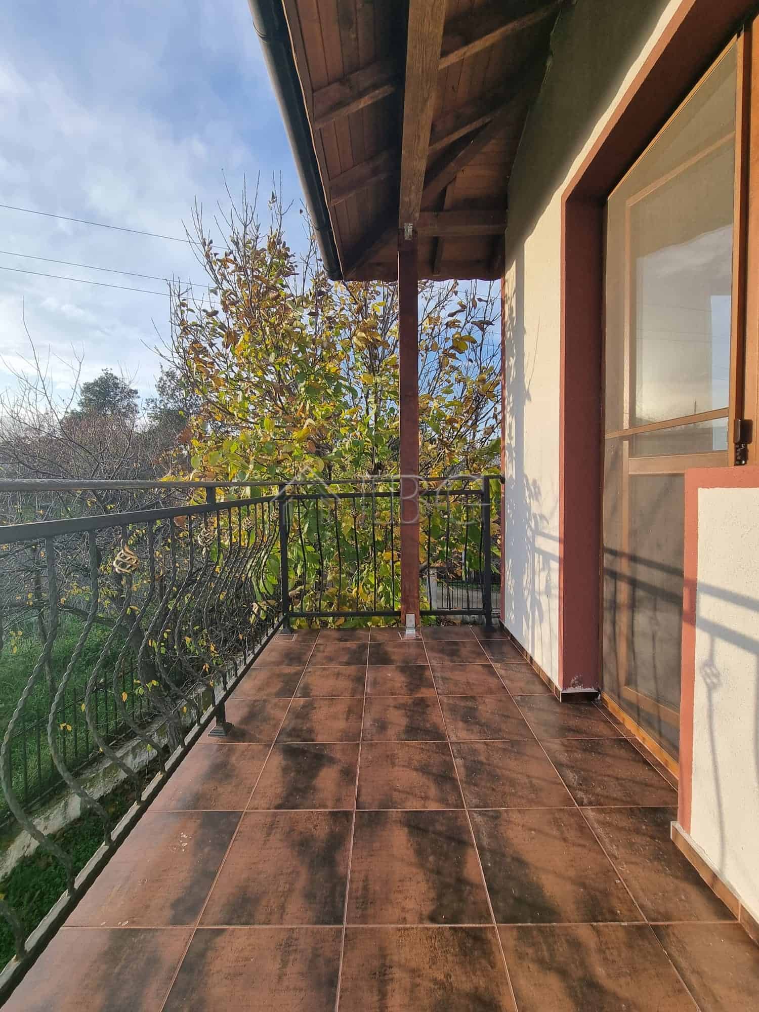 Balcony view from a two-story house in Aleksandrovo, Burgas Region, showcasing rustic charm and scen.
