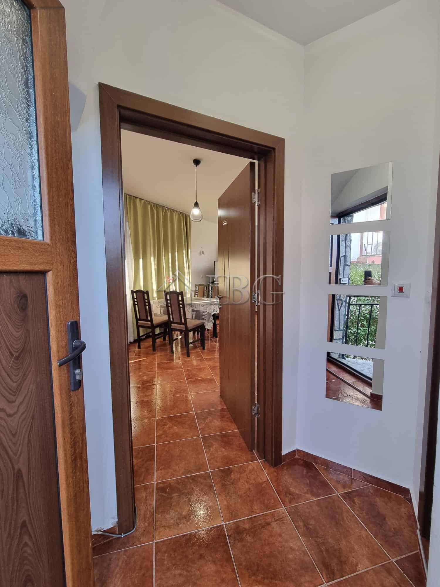 Bright entrance hall with wooden door and window in Aleksandrovo, Burgas Region.