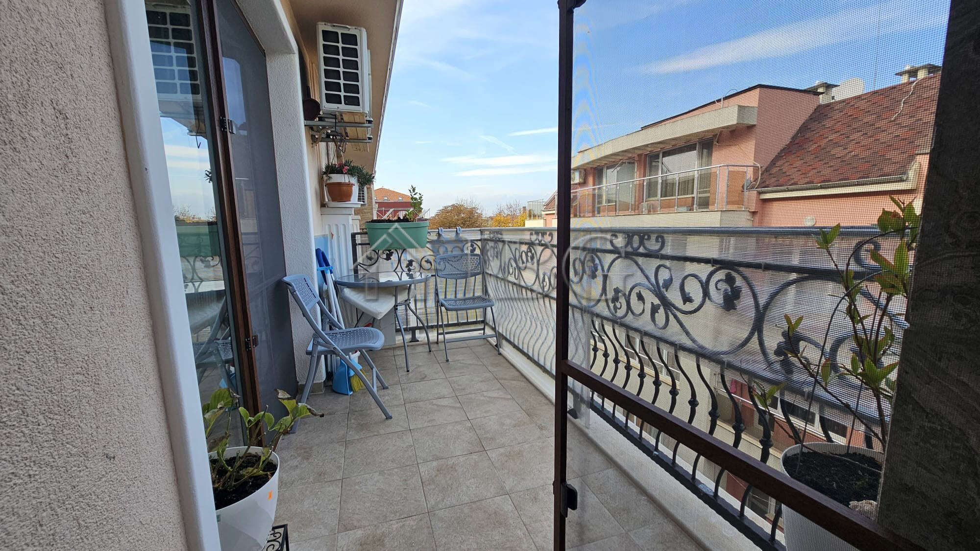 Balcony view of Nessebar with outdoor seating in a modern one-bedroom apartment.