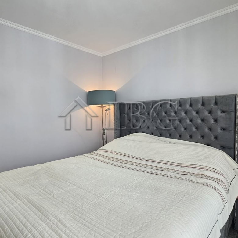 Bedroom with a large bed, tufted headboard, and soft lighting in Valencia Gardens, Nessebar.