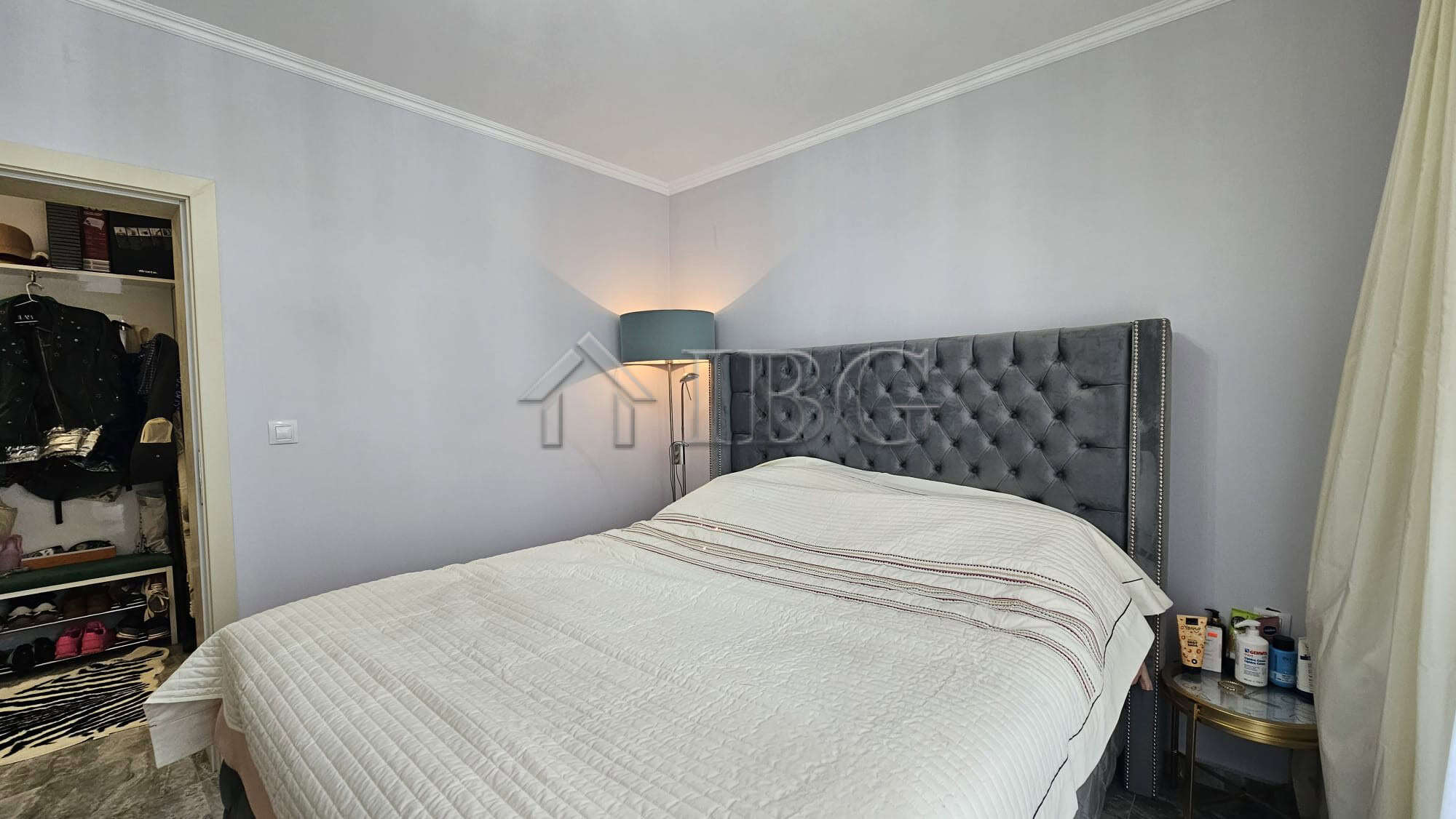 Bedroom with a large bed, tufted headboard, and soft lighting in Valencia Gardens, Nessebar.
