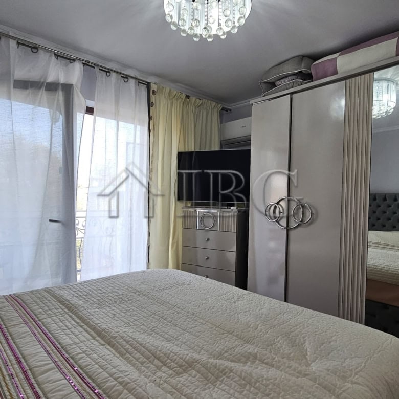 Spacious bedroom featuring a large wardrobe and natural light in Valencia Gardens, Nessebar.
