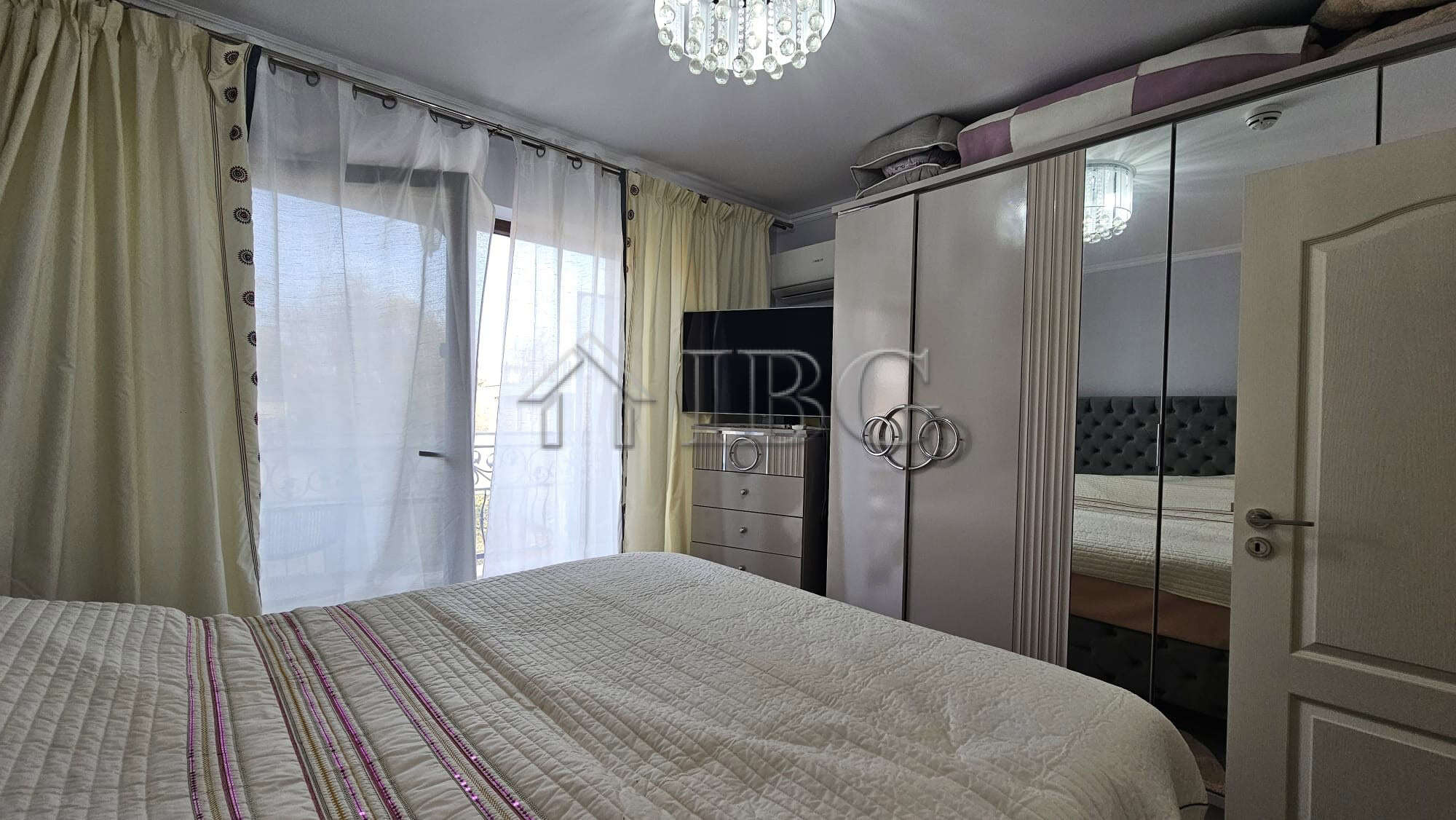 Spacious bedroom featuring a large wardrobe and natural light in Valencia Gardens, Nessebar.