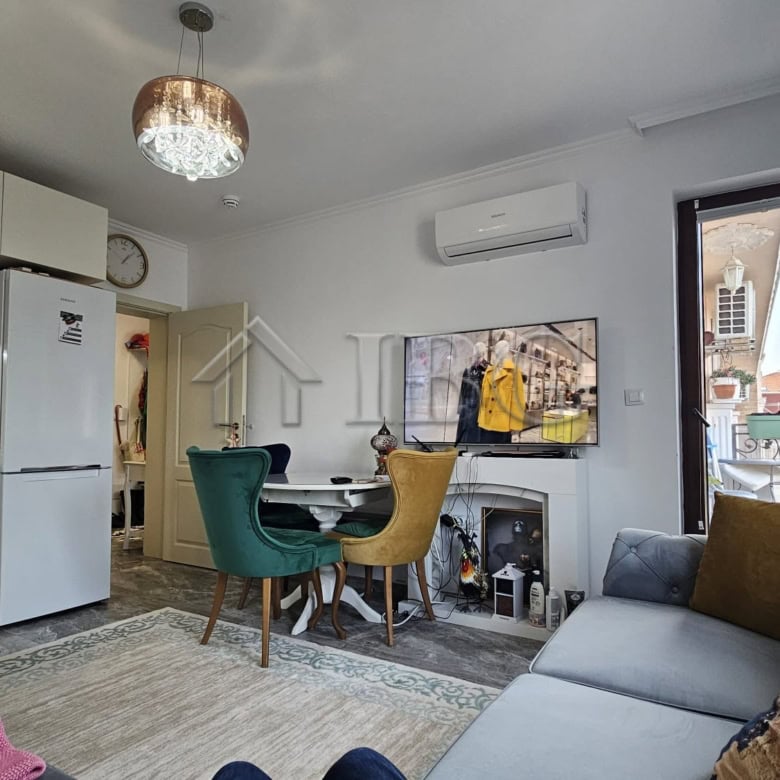 Interior view of a modern one-bedroom apartment in Nessebar with living area and kitchen.