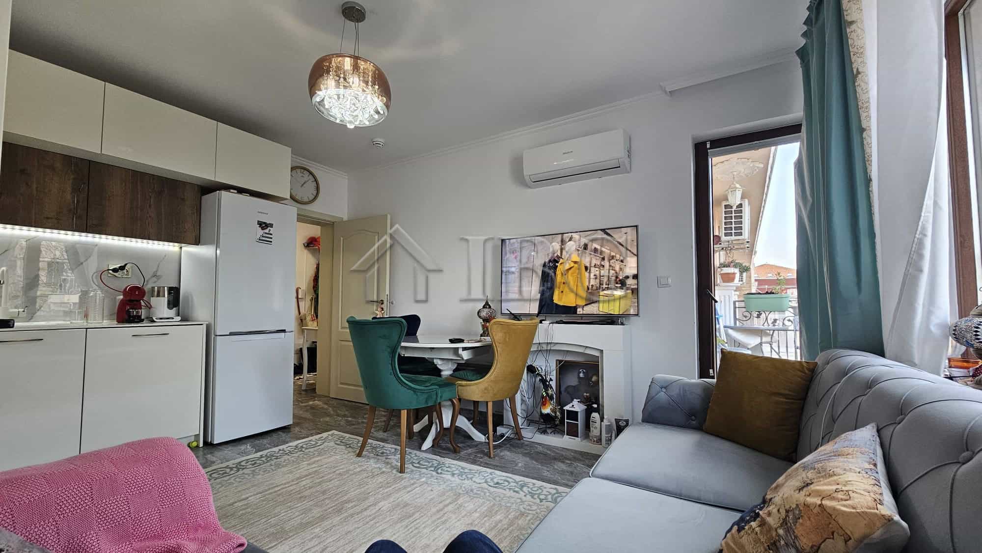 Interior view of a modern one-bedroom apartment in Nessebar with living area and kitchen.