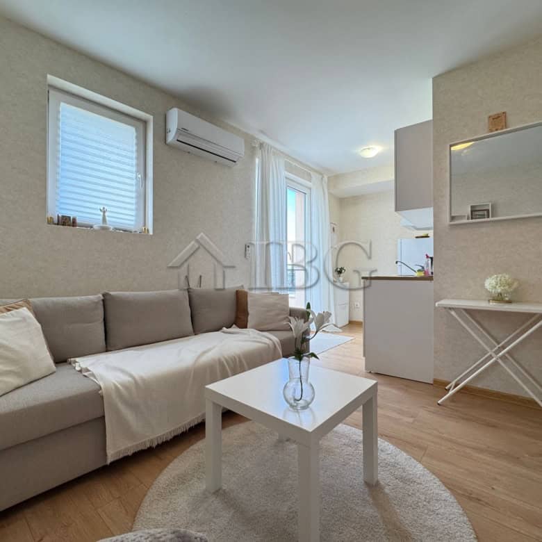 Bright living room with sofa, windows, and air conditioning in Aphrodite Park, Sunny Beach.