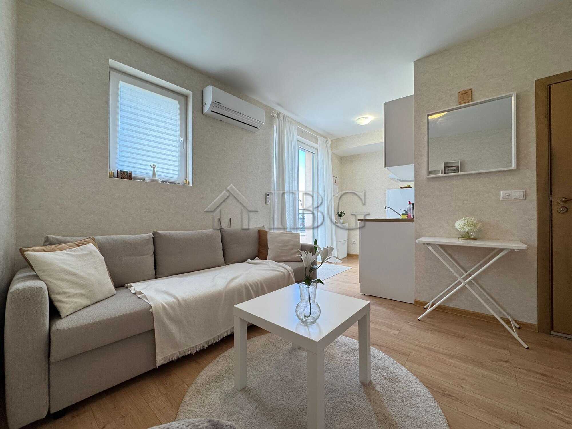 Bright living room with sofa, windows, and air conditioning in Aphrodite Park, Sunny Beach.