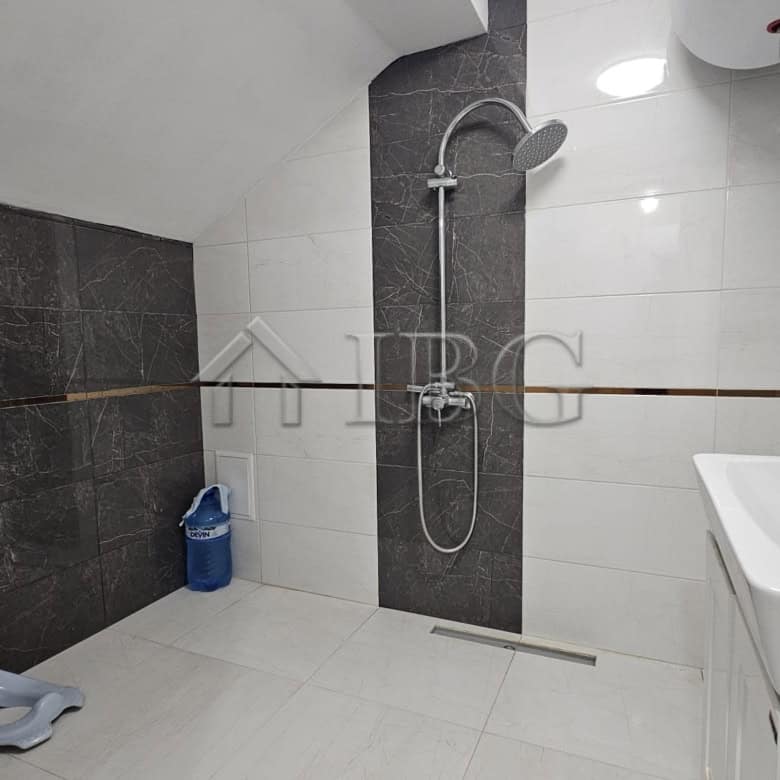 Bathroom with modern fixtures and shower area.