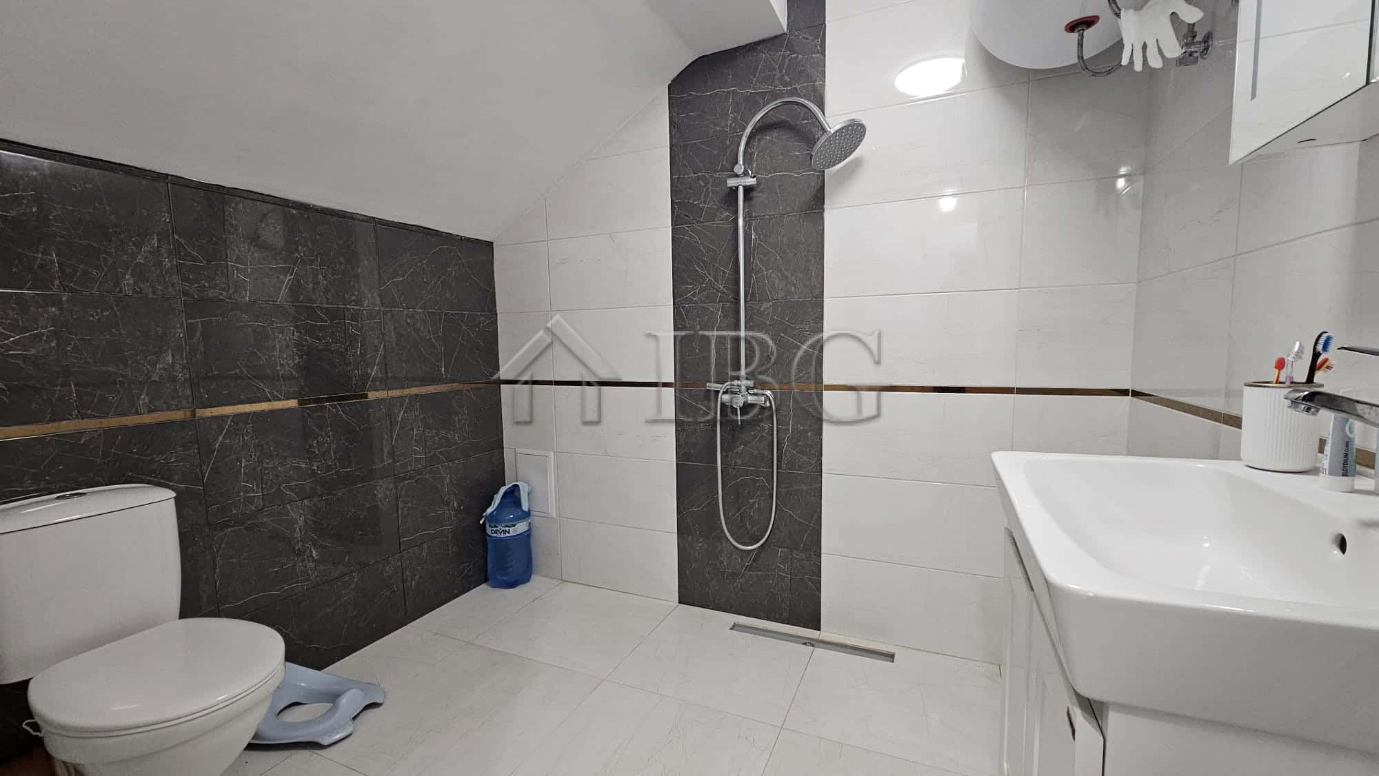 Bathroom with modern fixtures and shower area.