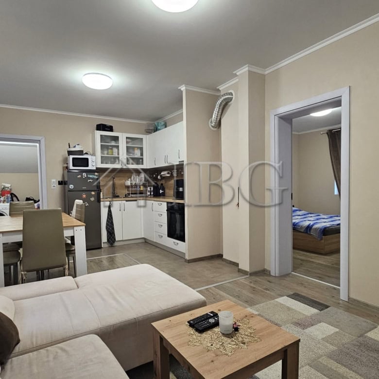 Spacious living room with modern furniture, open kitchen, and access to the yard in this house near.