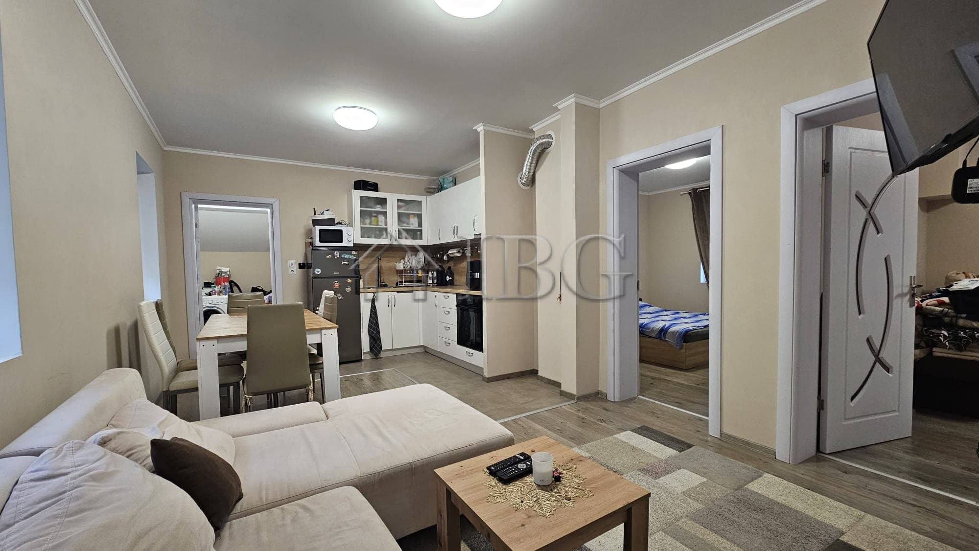Spacious living room with modern furniture, open kitchen, and access to the yard in this house near.