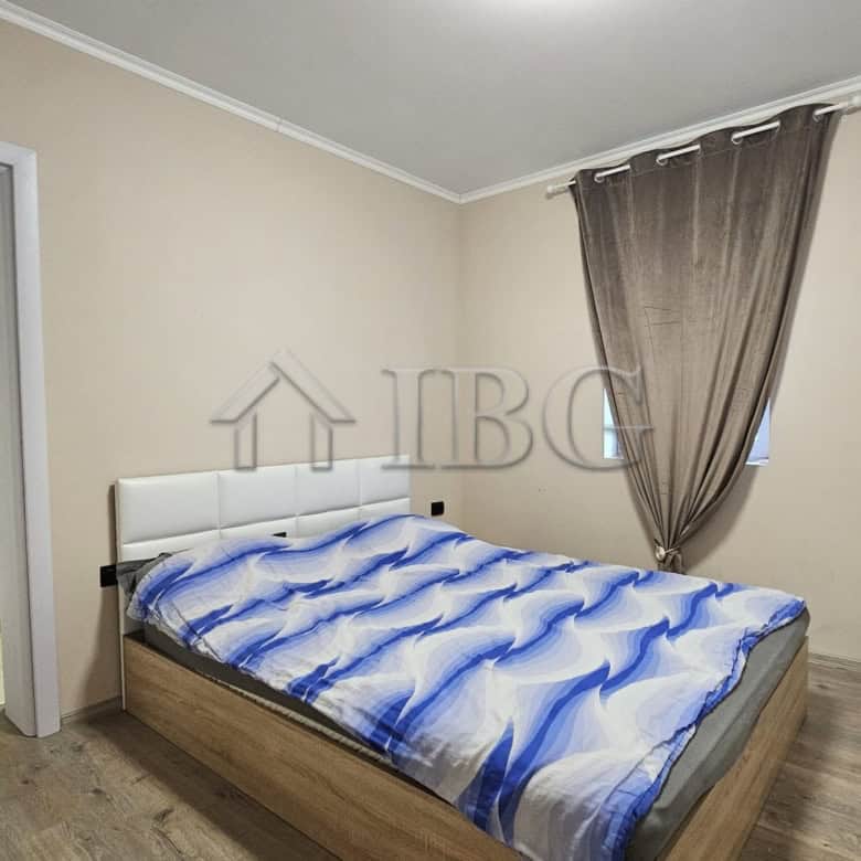 Spacious bedroom with modern decor, adjacent to a second bedroom, in a home near the sea.