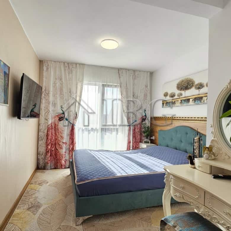 Modern renovated bedroom with blue bed and decorative accents near Sunny Beach.