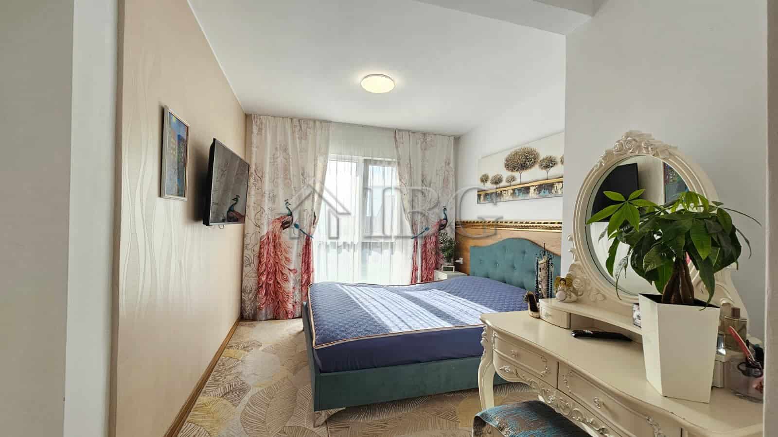 Modern renovated bedroom with blue bed and decorative accents near Sunny Beach.