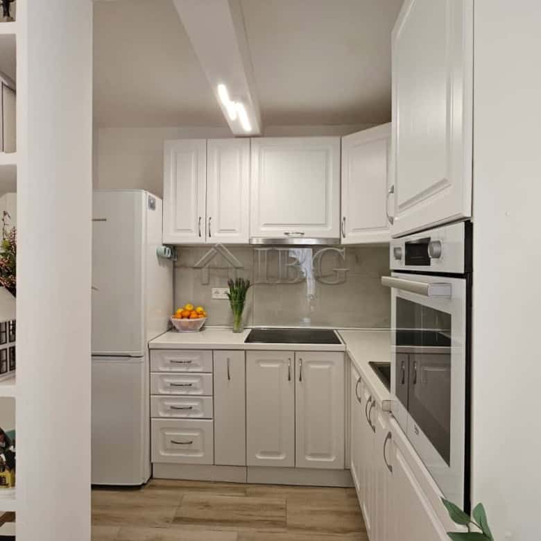 Modern white kitchen with appliances in renovated house near Sunny Beach, Kosharitsa.