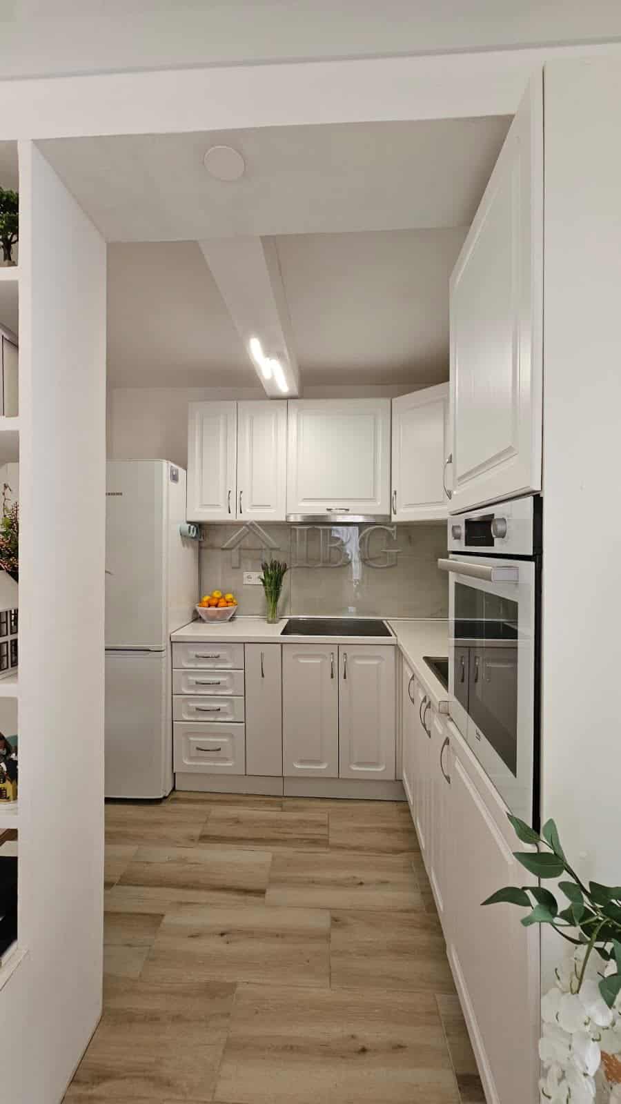 Modern white kitchen with appliances in renovated house near Sunny Beach, Kosharitsa.