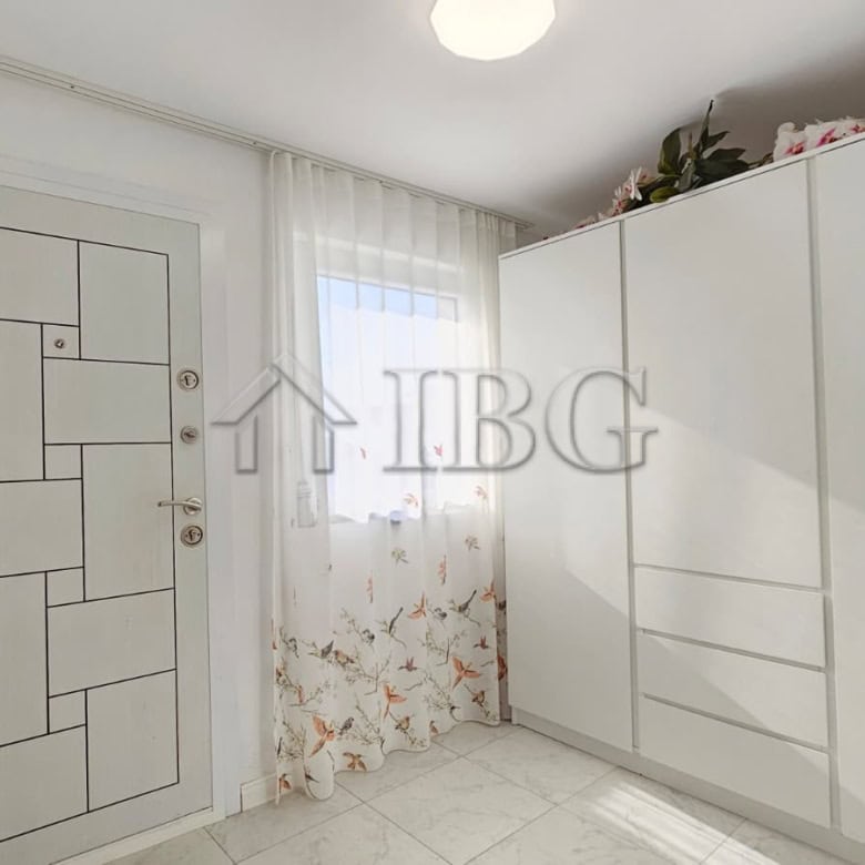 Bright bedroom with white wardrobe and window in renovated detached house near Sunny Beach.