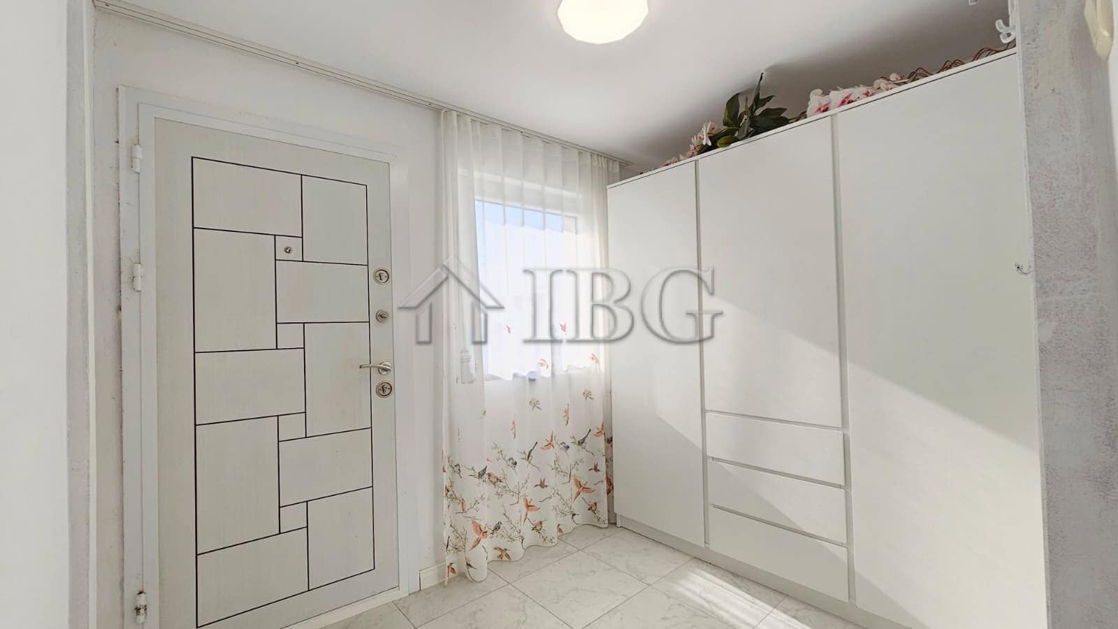 Bright bedroom with white wardrobe and window in renovated detached house near Sunny Beach.