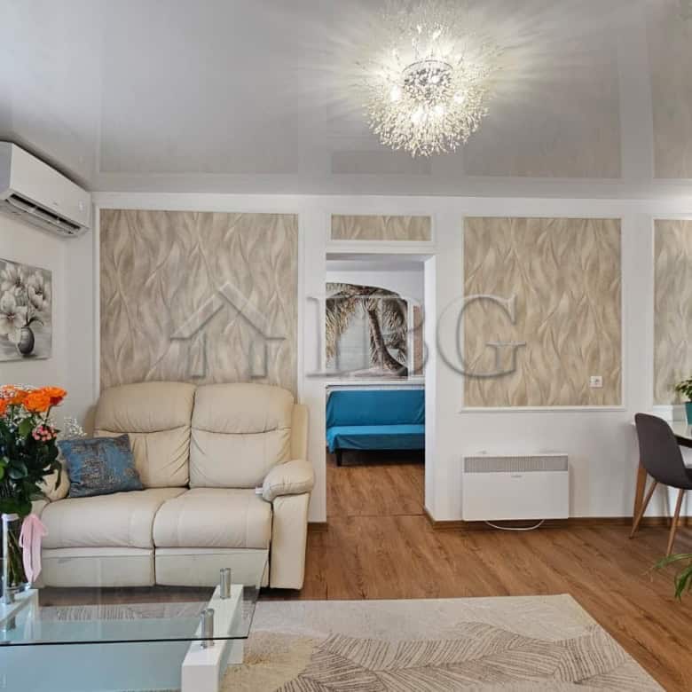 Spacious renovated living room featuring contemporary furniture, elegant decor, and bright natural l.