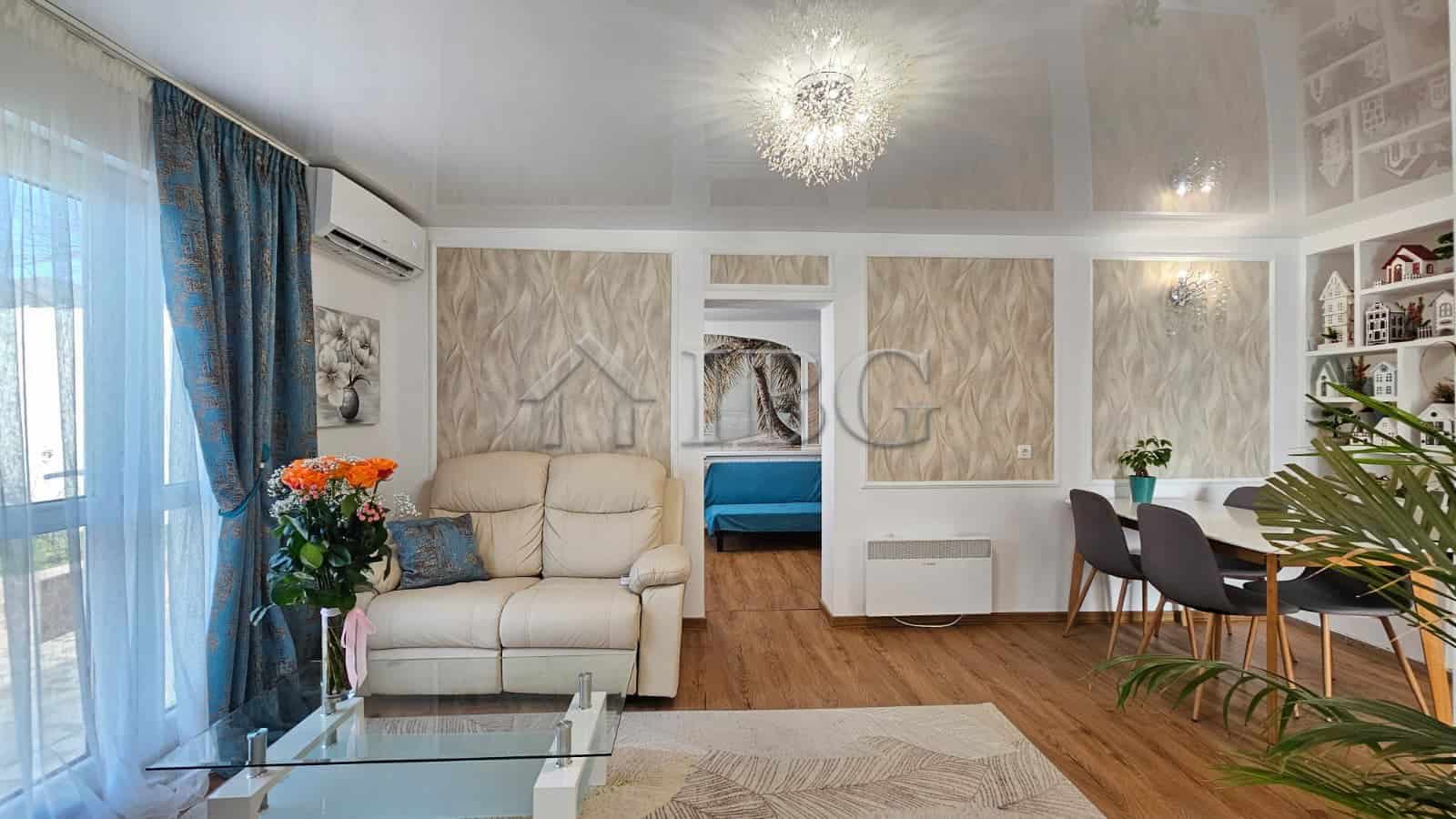 Spacious renovated living room featuring contemporary furniture, elegant decor, and bright natural l.
