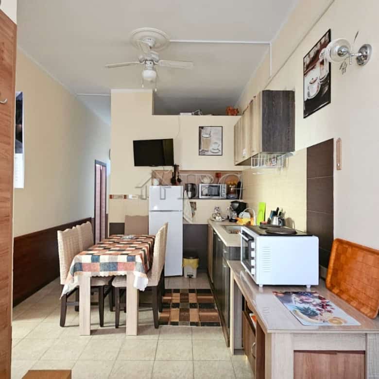 Bright kitchen with compact appliances in Sunny Beach property.