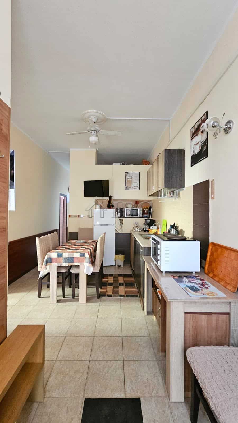 Bright kitchen with compact appliances in Sunny Beach property.