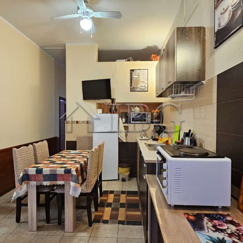 Kitchen with appliances and dining area in Sunny Beach commercial property.
