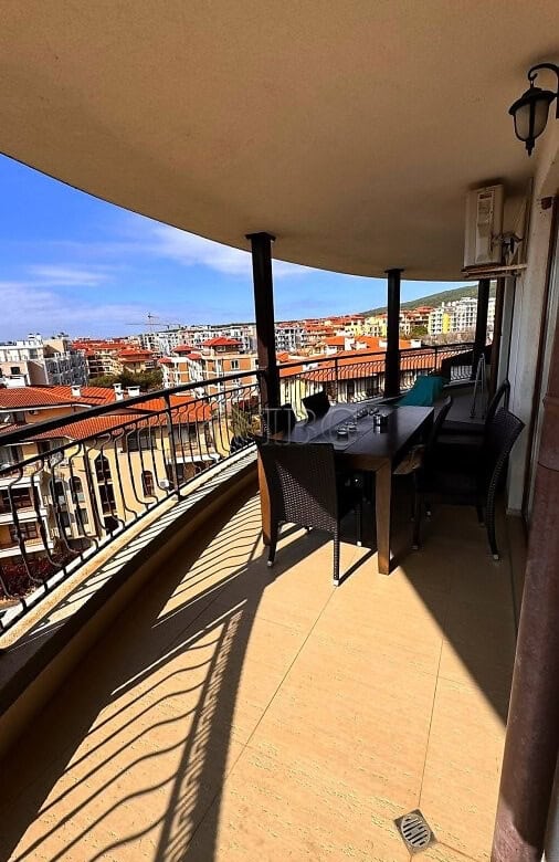 Balcony view of sea and pool from Sveti Vlas apartment with outdoor dining area.