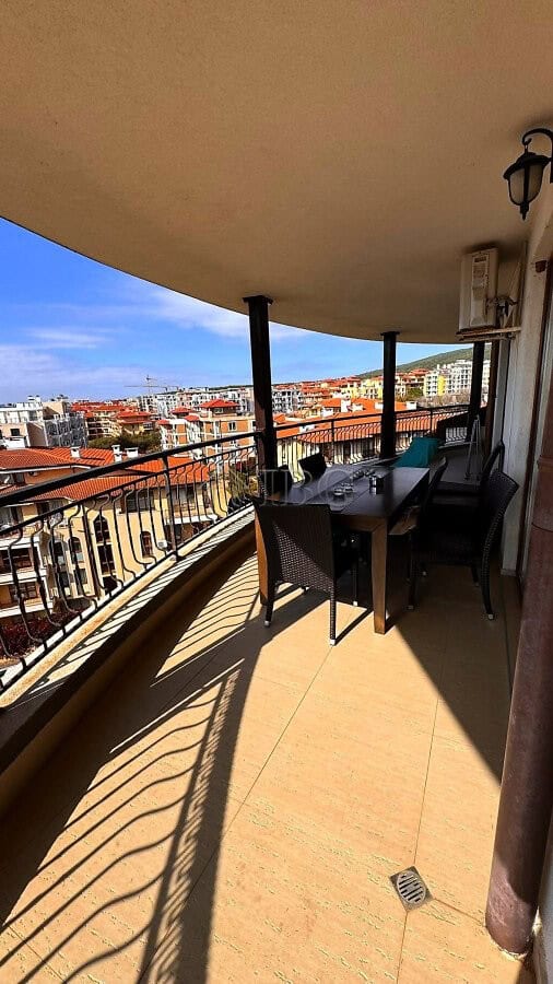 Balcony view of sea and pool from Sveti Vlas apartment with outdoor dining area.