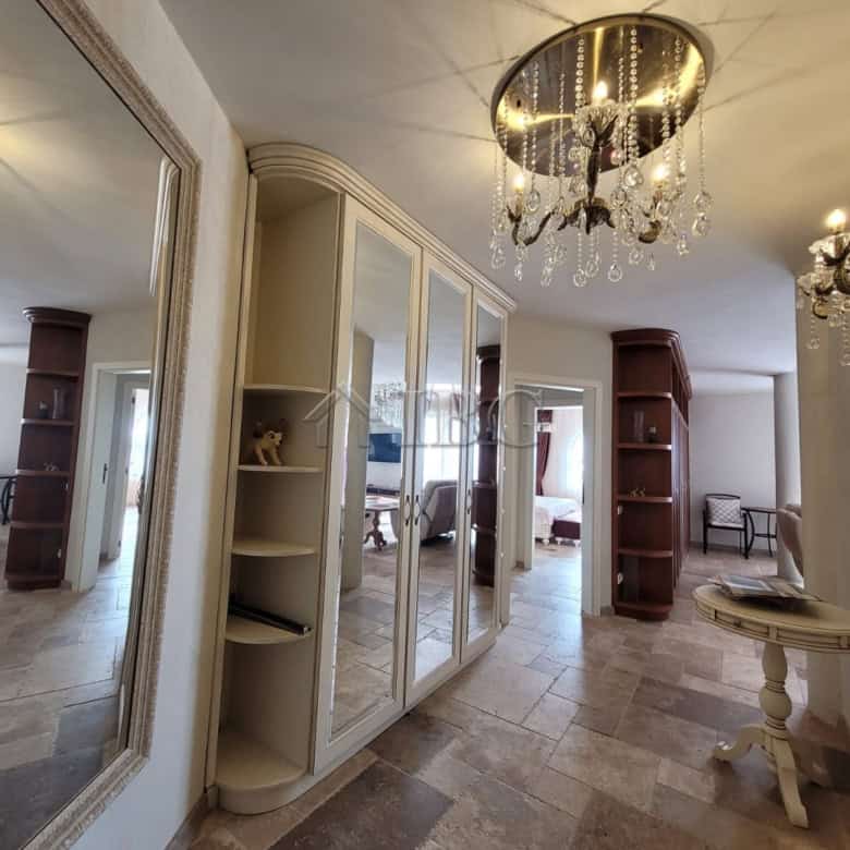 Elegant interior of a three-level maisonette featuring a chandelier and spacious living area.
