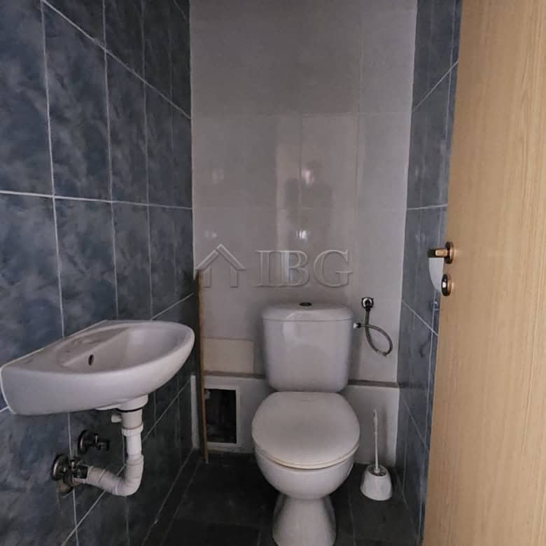 Compact bathroom with toilet and sink in a commercial property on Main Street, Sunny Beach.