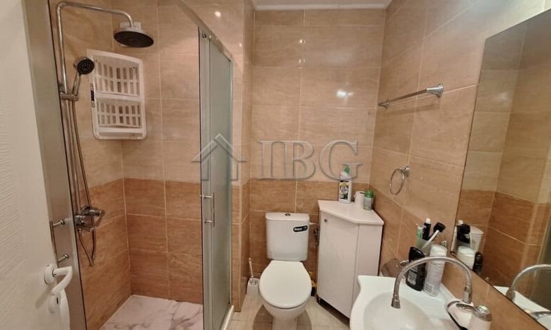 Bright bathroom with shower, toilet, and sink in a 2-bedroom apartment in Ravda.