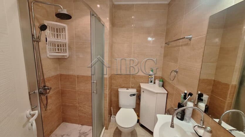 Bright bathroom with shower, toilet, and sink in a 2-bedroom apartment in Ravda.