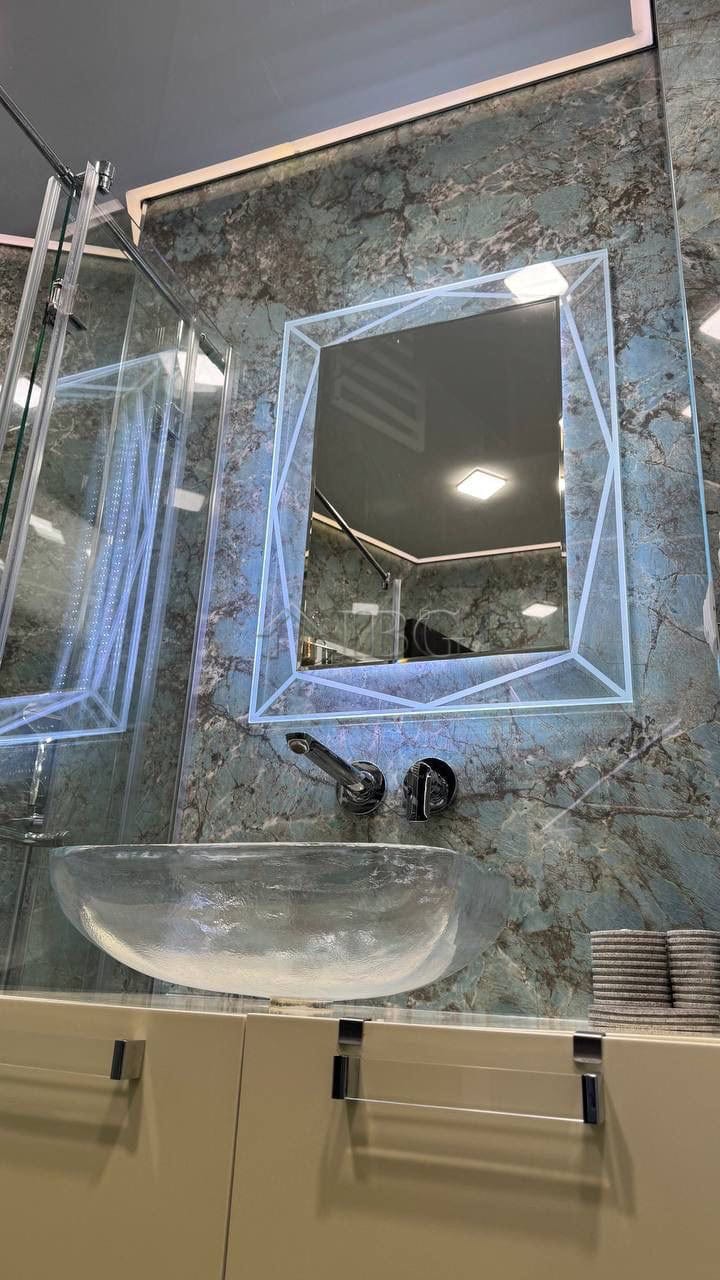 Illuminated mirror with LED lighting in a contemporary bathroom setting.