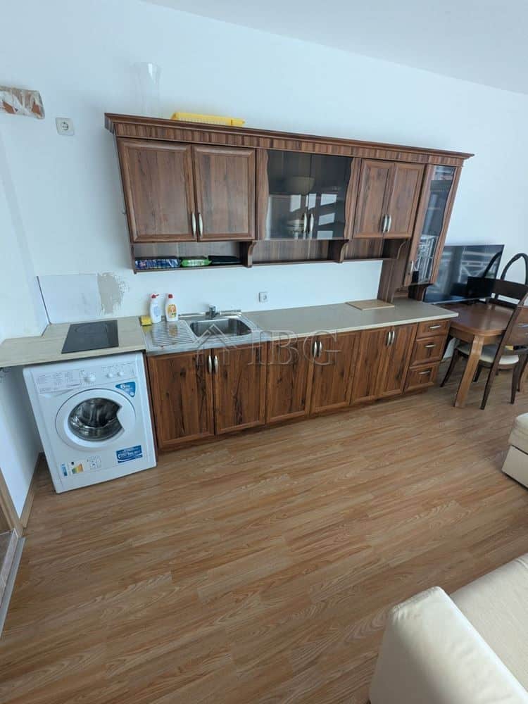 Furnished studio apartment with balcony in Sunny Beach, Bulgaria, featuring a compact kitchen and mo.
