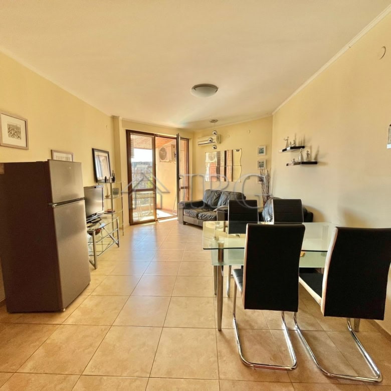 Bright living room with modern furniture and balcony views in Ravda.