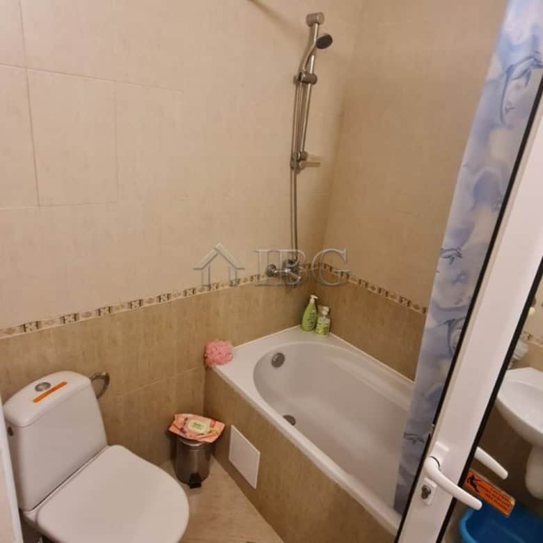 Small bathroom with bathtub, toilet, and shower in Golden Dreams apartment.
