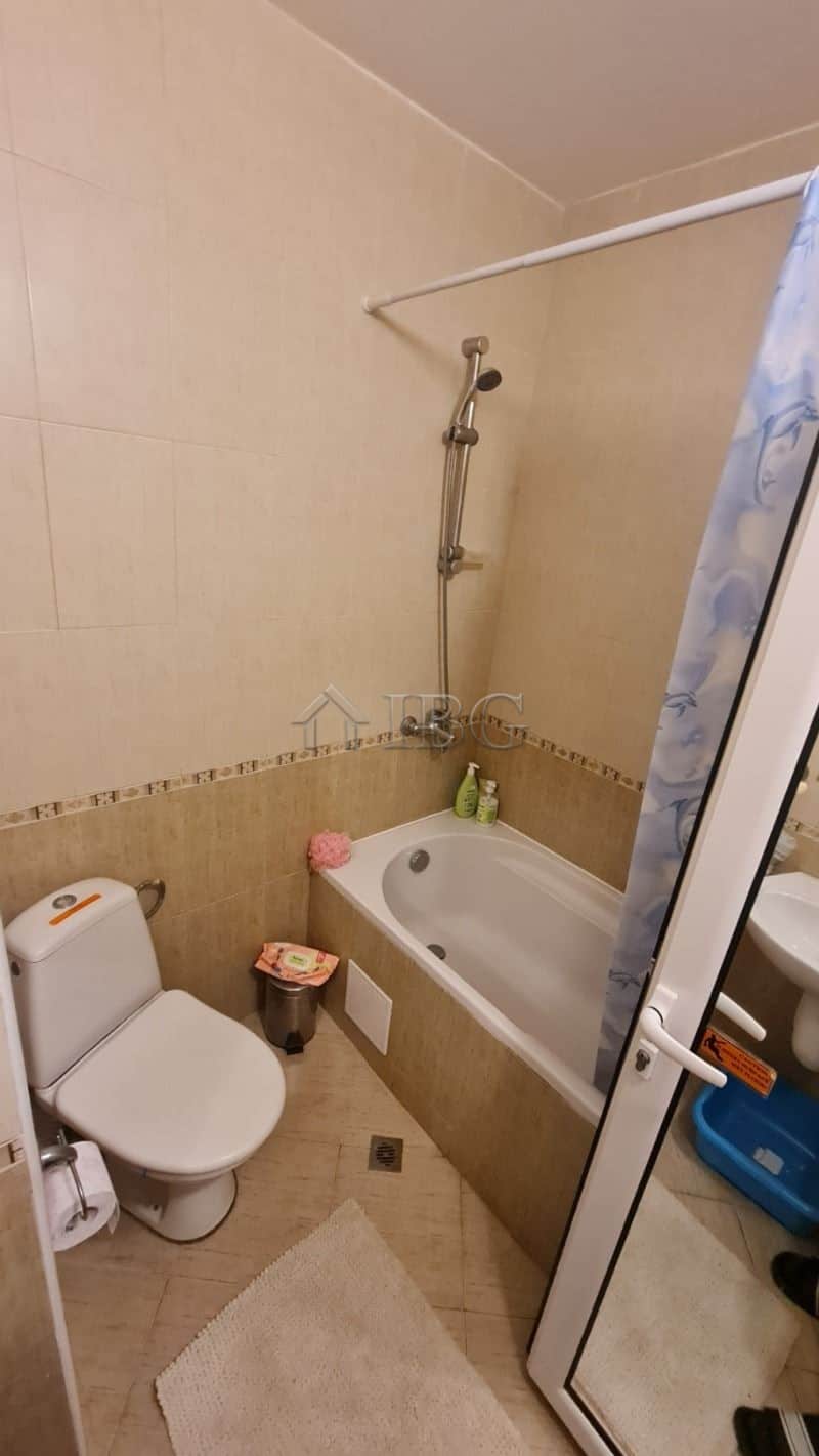 Small bathroom with bathtub, toilet, and shower in Golden Dreams apartment.