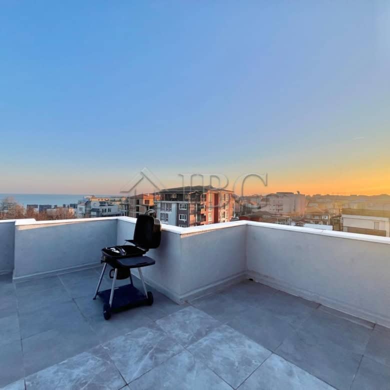 Terrace with sea view and outdoor seating in Ravda apartment.
