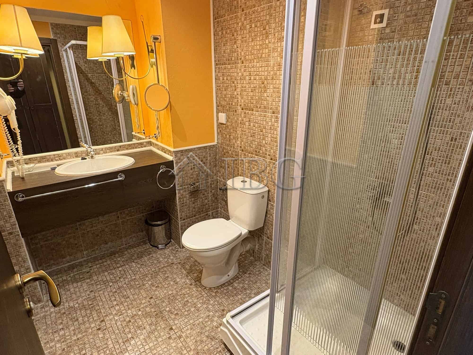 Cozy Bathroom with Shower at Royal Beach Barceló Modern bathroom with shower, toilet, and sink at Royal Beach Barceló, Sunny Beach.