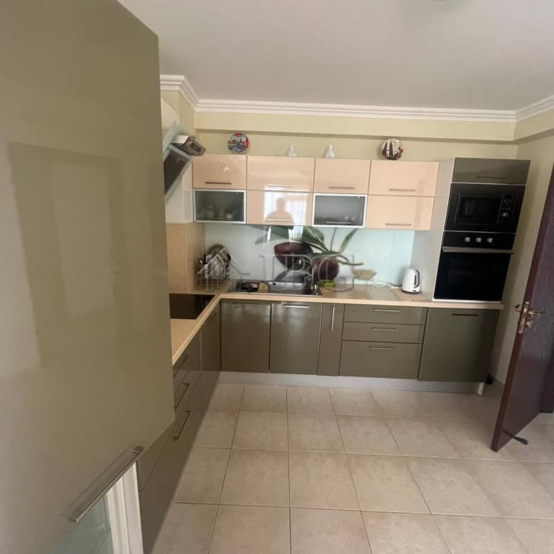 Kitchen with beige cabinets and modern appliances in Sveti Vlas.