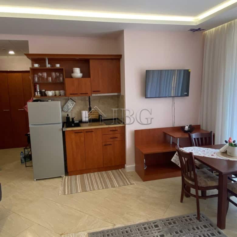 Bright studio apartment with pool view in Palazzo complex, Sunny Beach. Modern interior, kitchenette.