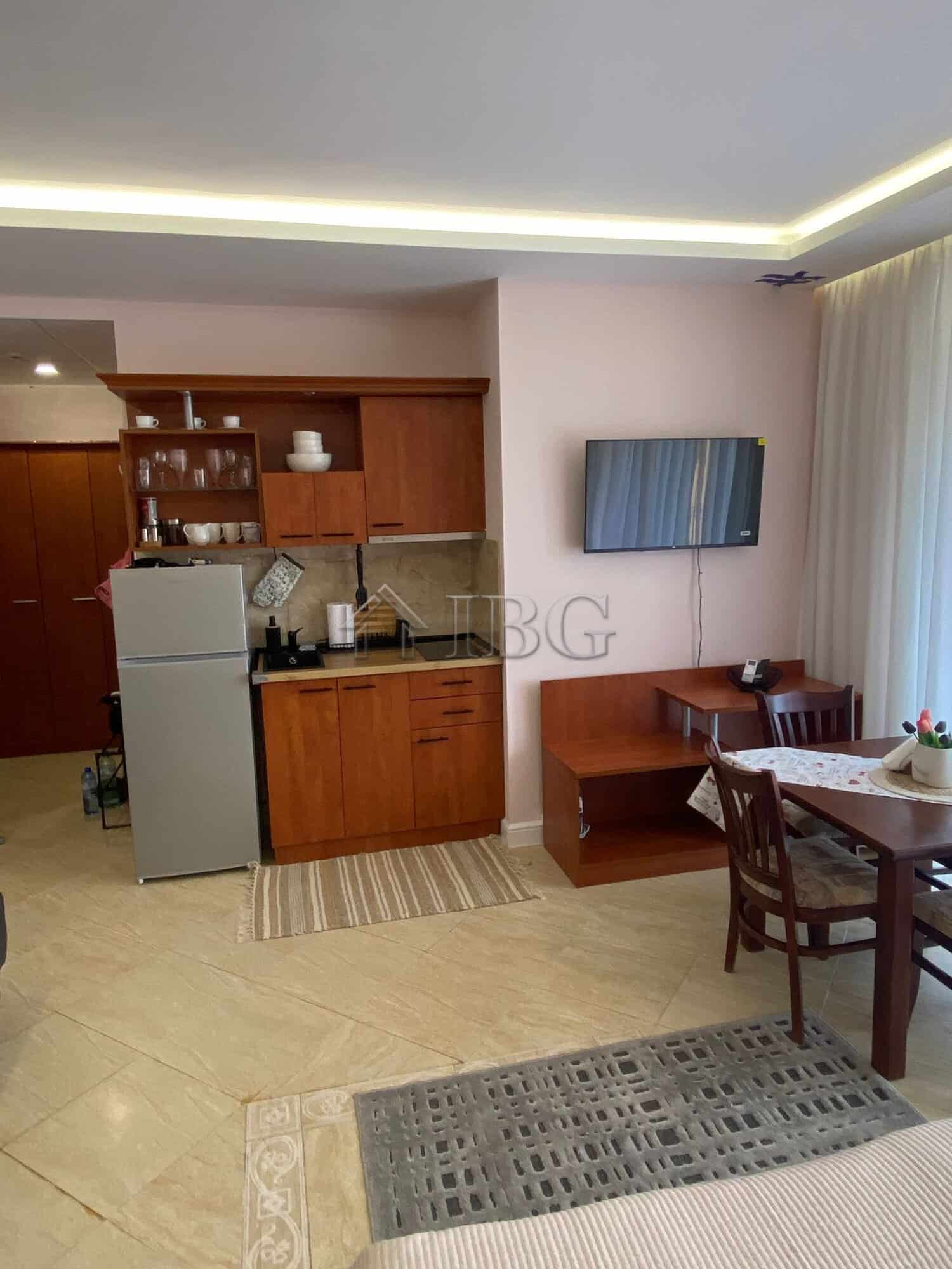 Bright studio apartment with pool view in Palazzo complex, Sunny Beach. Modern interior, kitchenette.